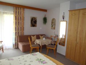 a living room with a couch and a table at Haus Elisabeth in Unterwössen