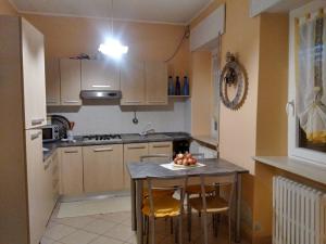 a kitchen with a table with a bowl of fruit on it at Cà Romi in Volta Mantovana +29 photos