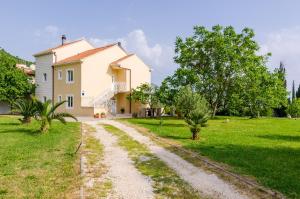 a house with a dirt road in front of it at Color Apartments in Mlini