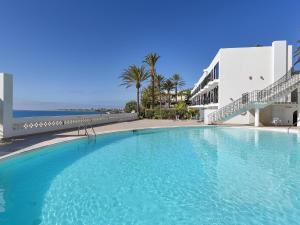 een groot blauw zwembad naast een gebouw bij Sea Haven 101 by VillaGranCanaria in San Agustin