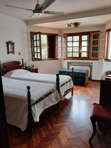 a large bedroom with two beds and a fireplace at Dos Balcones in Salta