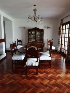 a dining room with a table and chairs and a chandelier at Dos Balcones in Salta