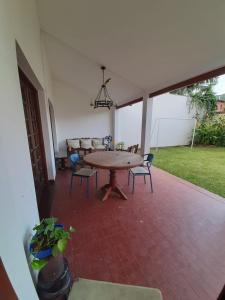 a patio with a table and chairs in a room at Dos Balcones in Salta +32 photos