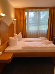 a bedroom with a large bed with a window at Appartement Hotel Marolt in Sankt Kanzian