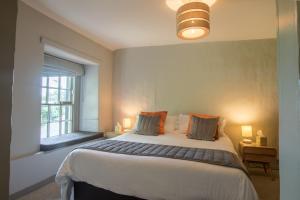 a bedroom with a large bed and a window at The Church House in Torver