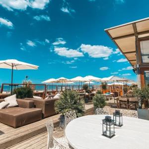 a outdoor patio with tables and chairs and umbrellas at casa Heemskerk in Noordwijk