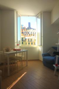 a living room with a table and a couch and a window at Vernazza Vacation 2 in Vernazza