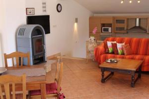 a living room with a red couch and a table at Amphora Deluxe in Vrboska