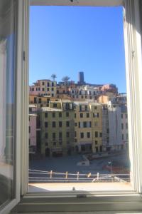 a window with a view of a city at Vernazza Vacation 2 in Vernazza