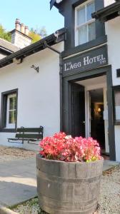 a barrel with flowers in front of a hotel at The Lagg in Lagg