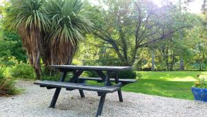 a picnic table and bench in a park at The Lagg in Lagg