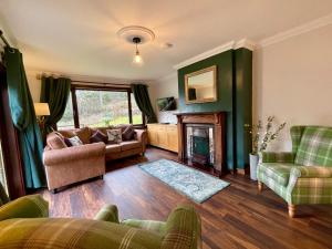 a living room with a couch and a fireplace at Ben Bheula in Arrochar