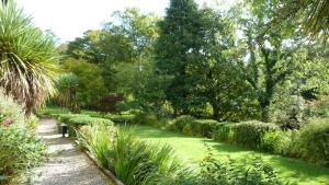 a garden with green grass and trees and bushes at The Lagg in Lagg