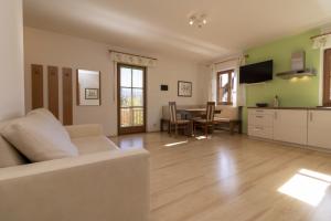 a living room with a couch and a table at Stompferhof Familienapartment in Caldaro