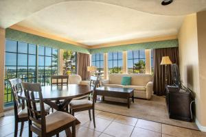 a living room with a table and a couch at Sea Shells Beach Club in Daytona Beach