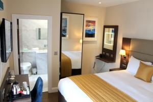 a hotel room with a bed and a bathroom at Joyce's Carndonagh Inishowen in Carndonagh