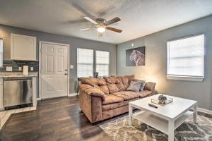 a living room with a couch and a table at Lees Summit Home Less Than 4 Mi to Dtwn Main Street in Lees Summit