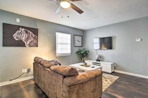 a living room with a couch and a tv at Lees Summit Home Less Than 4 Mi to Dtwn Main Street in Lees Summit
