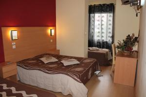 a hotel room with a bed and a desk at Guest House Estrela in Porto