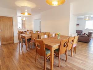 a dining room with a wooden table and chairs at The Bull Inn in Caernarfon