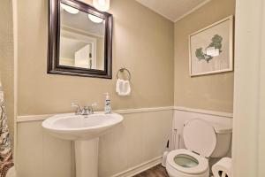 a bathroom with a sink and a toilet and a mirror at Rockport Bayfront Studio with Patio Casa Familia in Rockport +17 photos