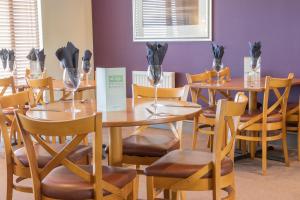 a dining room with wooden tables and chairs at Purdy Lodge in Belford