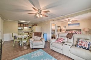 a living room with a couch and a ceiling fan at Rockport Bayfront Studio with Patio Casa Familia in Rockport