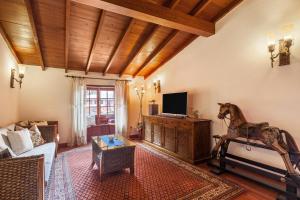 Sala de estar con sofá y estatua de caballo en Finca Los Viñedos Casa Rural en Tacoronte