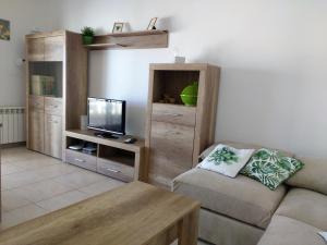 a living room with a couch and a flat screen tv at AME737 in Les tres Cales