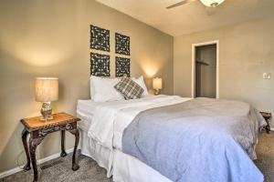 a bedroom with a bed and a table with a lamp at Manitou Springs Condo with Hammock and Mtn Views! in Manitou Springs