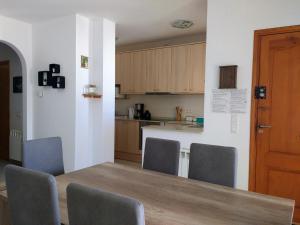 a kitchen with a table and chairs and a counter at AME737 in Les tres Cales