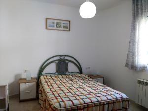 a bedroom with a bed with a patterned blanket at AME737 in Les tres Cales +37 photos