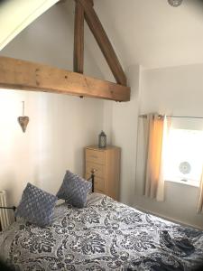 a bedroom with a bed with pillows on it at Grand Central Apartments, The Mill in Derby