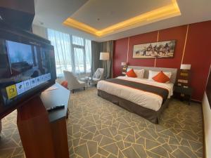 En eller flere senge i et værelse på Velar Inn Hotel