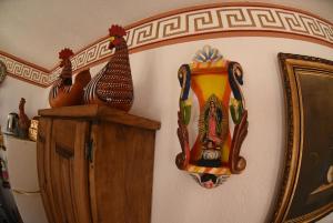 a group of vases on a wall next to a shelf at HOTEL CASA LIMON in Santa Rosa de Jáuregui