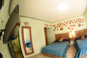 A bed or beds in a room at HOTEL CASA LIMON
