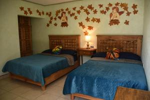 A bed or beds in a room at HOTEL CASA LIMON