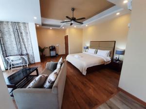 a large bedroom with a bed and a couch at Shalom Farmhouse by the hillside in Imphal +60 photos