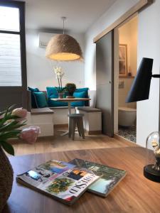 a living room with a blue couch and a table at Loft Terrasse, l'Hauture, Arles in Arles