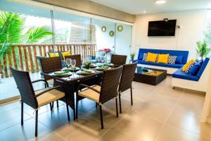 a dining table and chairs in a living room at Departamento Las Palmeras de Bocapán 201 in Zorritos