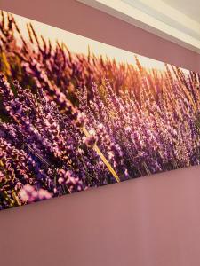 a painting of a field of flowers on a wall at Affittacamere Le Grotte - Le Grotte Rooms & Apartments in Camerano