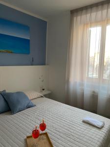 a bedroom with a bed with two red candles on it at Affittacamere Le Grotte - Le Grotte Rooms & Apartments in Camerano