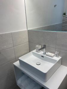 a bathroom with a white sink and a mirror at Affittacamere Le Grotte - Soggiorni Le Grotte in Camerano +42 photos