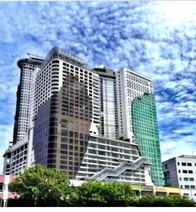 a tall building with a cloudy sky in the background at Silverscape Residence Melaka in Melaka