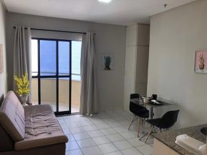a living room with a couch and a table at Flat no Executive Arrey Hotel in Teresina