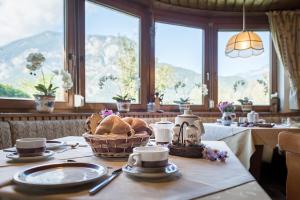 un tavolo con un cesto di pane su un tavolo con finestre di Gästehaus Hechenblaikner a Maurach