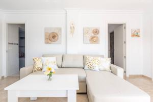 a white living room with a couch and a table at Charming Villa in Competa with Private Pool in Cómpeta