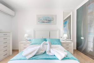 two swans are sitting on a bed with towels at Charming Villa in Competa with Private Pool in Cómpeta