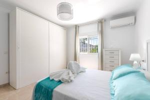 a white bedroom with a bed and a window at Charming Villa in Competa with Private Pool in Cómpeta +26 photos