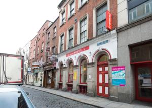 uma rua da cidade com muitos edifícios e uma rua com em The Apache Hostel em Dublin